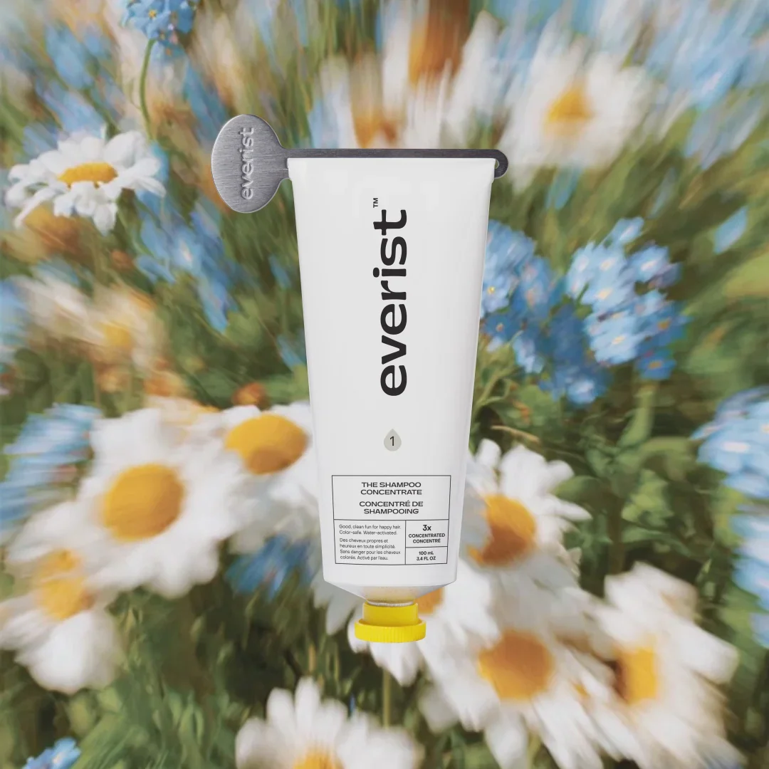 White concentrate tube resting on wildflowers.