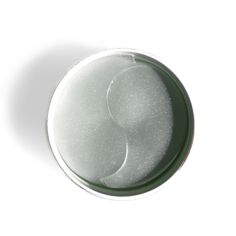 Open jar of clear hydrogel eye patches seen from above.